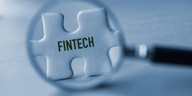 Magnifying glass and puzzle piece. Financial technology.